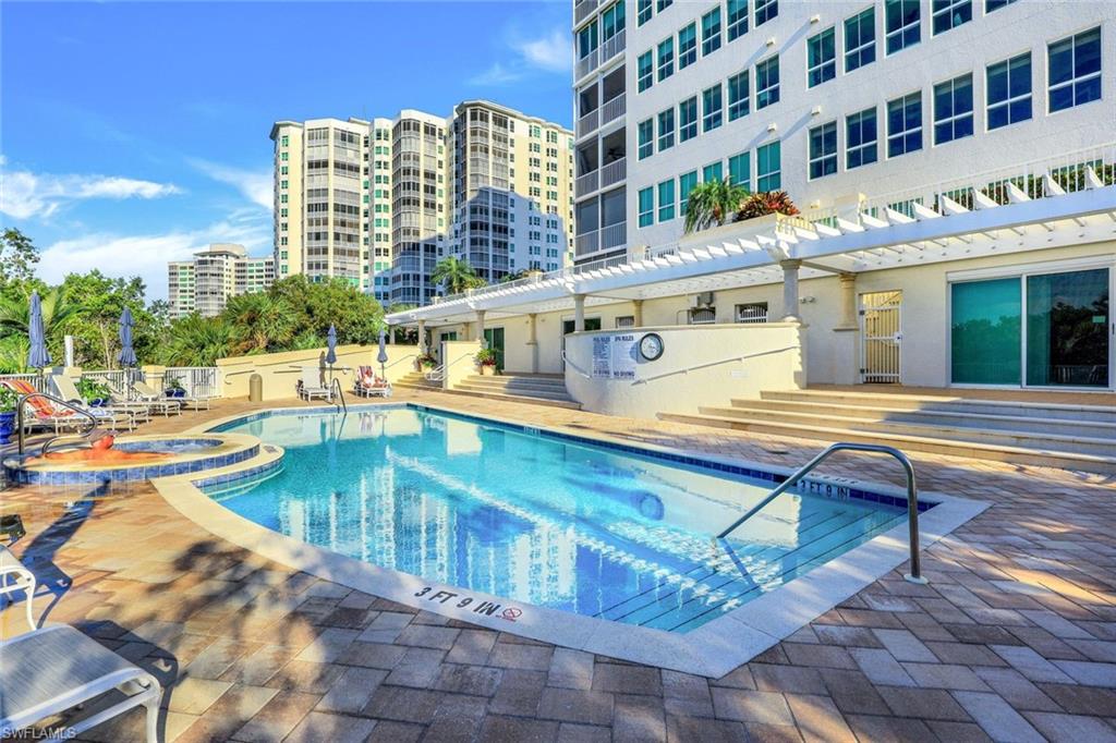 295 Grande Way, Unit 306 Naples, FL 34110 - Photo 30 of 48 a view of a swimming pool with outdoor seating