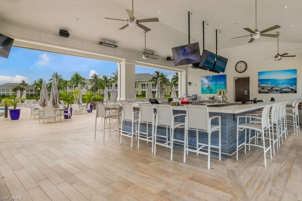 295 Grande Way, Unit 306 Naples, FL 34110 - Photo 35 of 48 a view of a dining room with furniture window and wooden floor