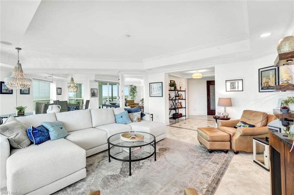 295 Grande Way, Unit 306 Naples, FL 34110 - Photo 6 of 48 a living room with furniture and a table