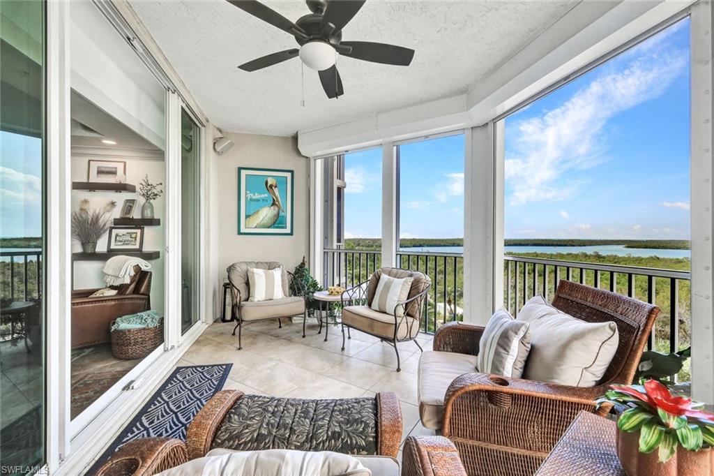 295 Grande Way, Unit 306 Naples, FL 34110 - Photo 8 of 48 a living room with furniture and a floor to ceiling window