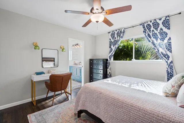 a bedroom with a bed a chair and a chandelier