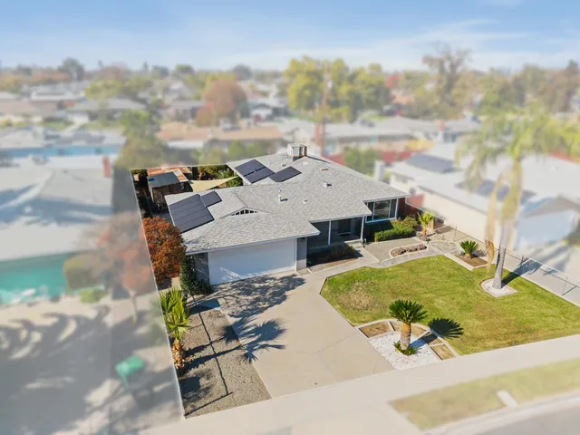an aerial view of a house with swimming pool and sitting space