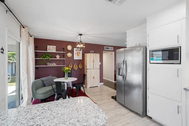 a living room with furniture wooden floor and a chandelier