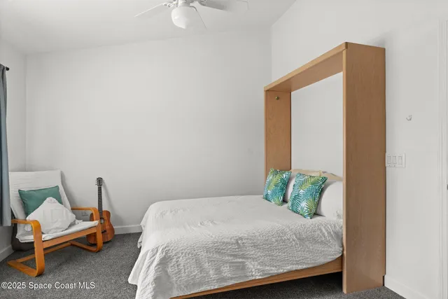 a bedroom with a bed and chair