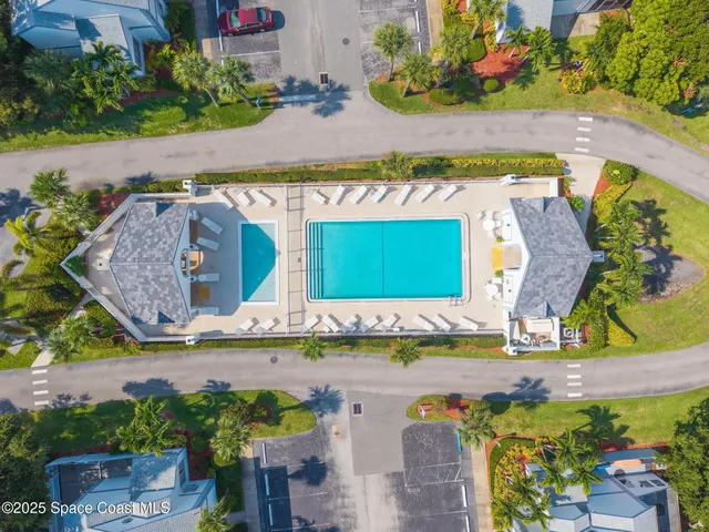 an aerial view of a house with a swimming pool