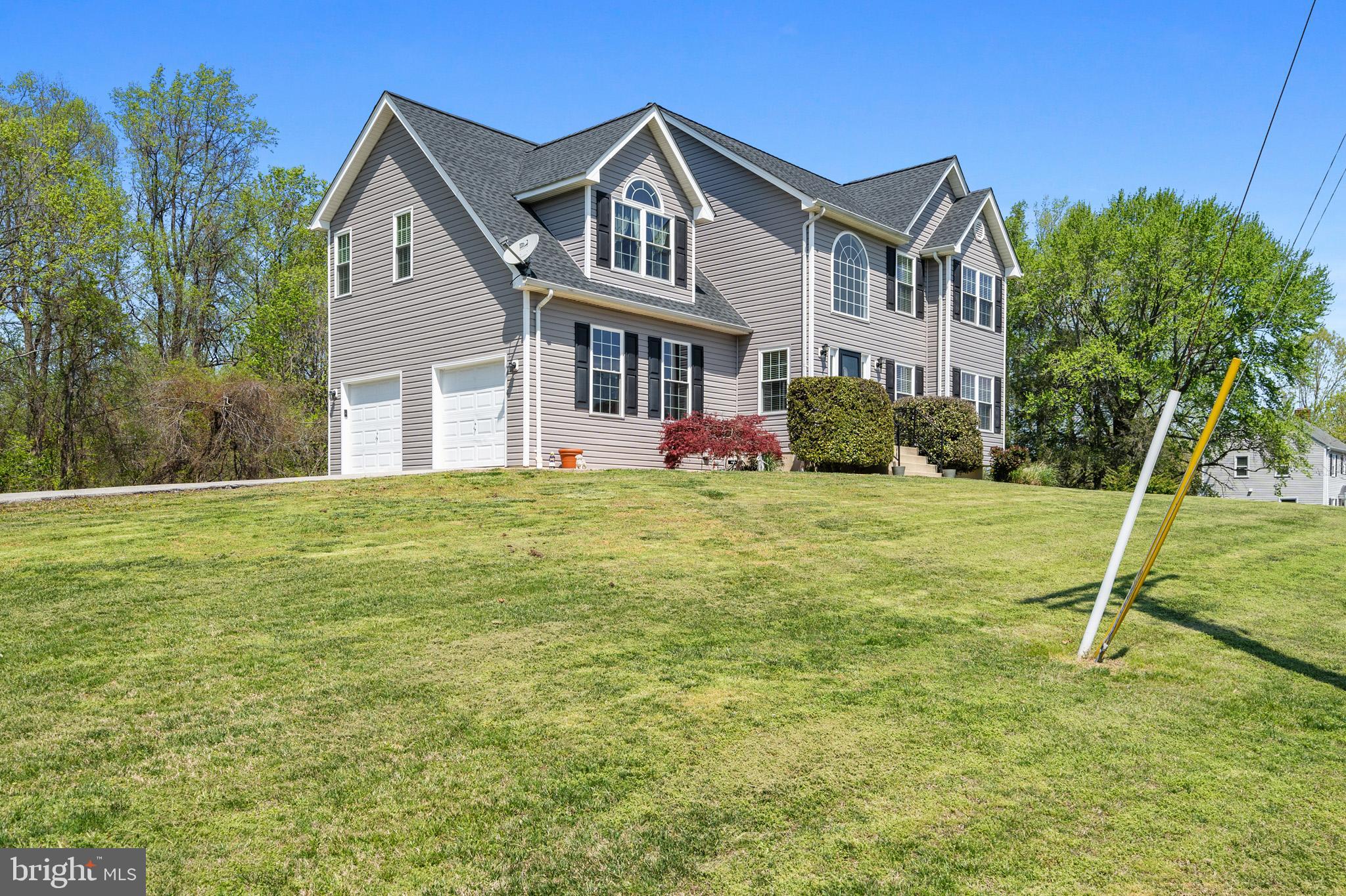 1230 Plum Point Road Huntingtown, MD 20639 - Photo 2 of 79 a front view of a house with a yard
