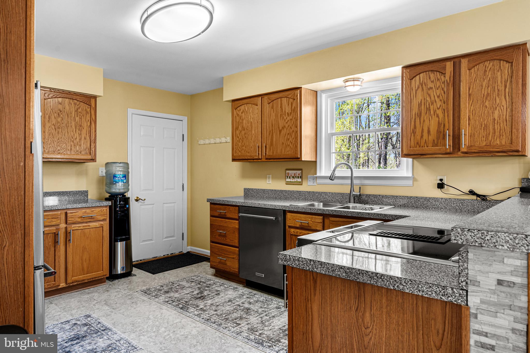 1230 Plum Point Road Huntingtown, MD 20639 - Photo 22 of 79 a kitchen with a stove a sink and a refrigerator