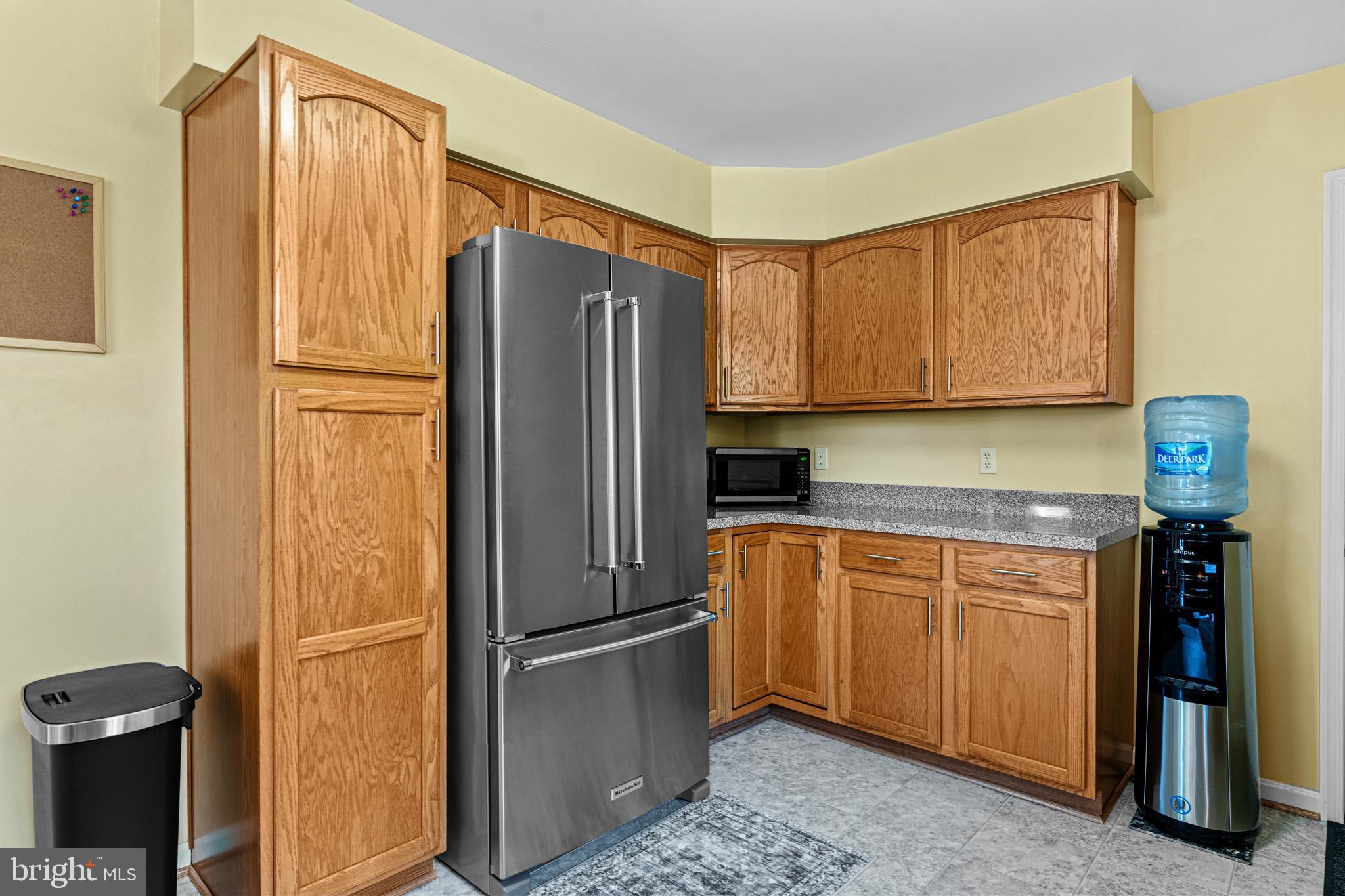 1230 Plum Point Road Huntingtown, MD 20639 - Photo 27 of 79 a kitchen with stainless steel appliances granite countertop a refrigerator and a sink