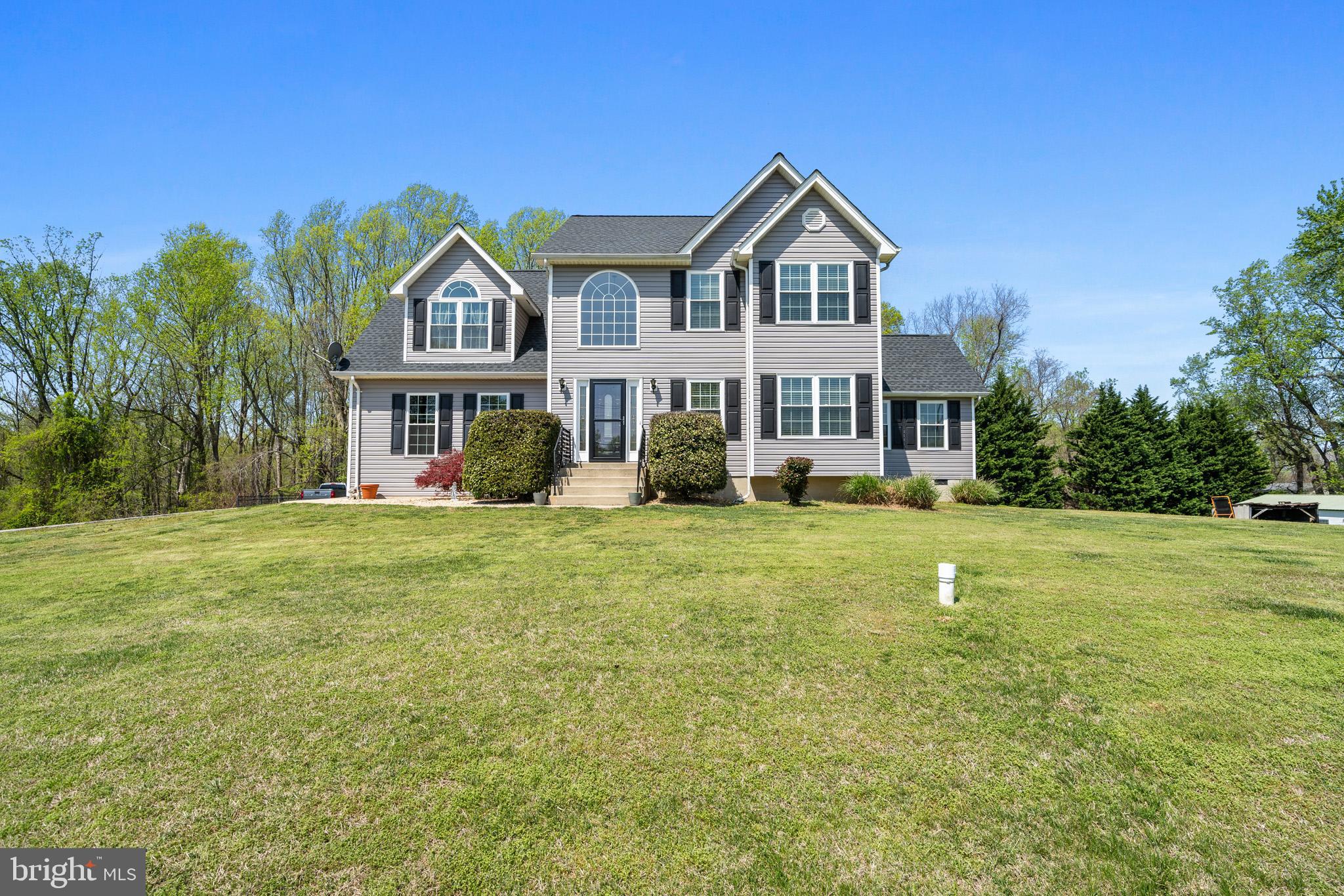 1230 Plum Point Road Huntingtown, MD 20639 - Photo 3 of 79 a front view of a house with garden
