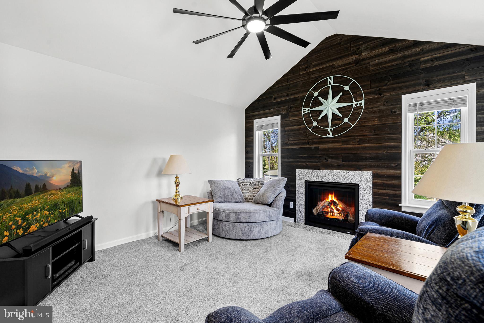 1230 Plum Point Road Huntingtown, MD 20639 - Photo 33 of 79 a living room with furniture and a fireplace