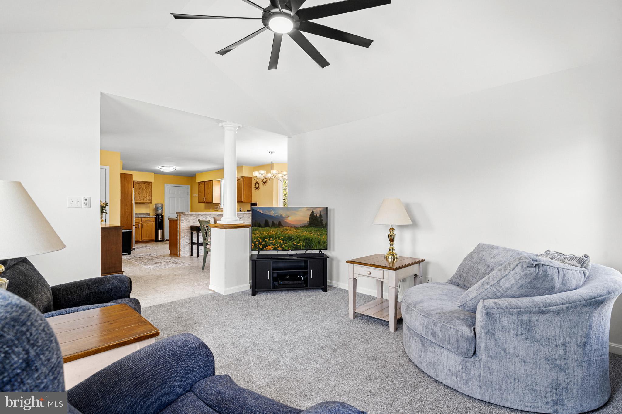 1230 Plum Point Road Huntingtown, MD 20639 - Photo 35 of 79 a living room with furniture and a view of kitchen