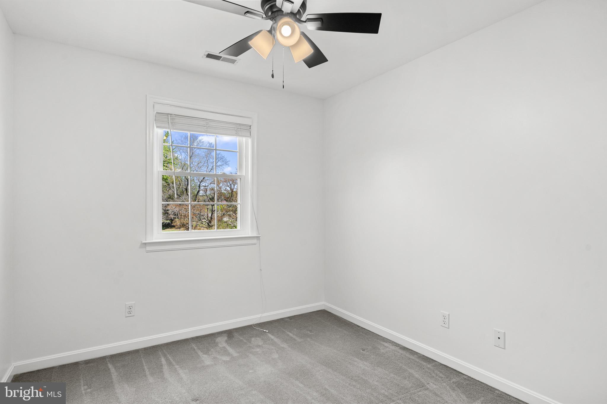1230 Plum Point Road Huntingtown, MD 20639 - Photo 38 of 79 an empty room with a window and a fan