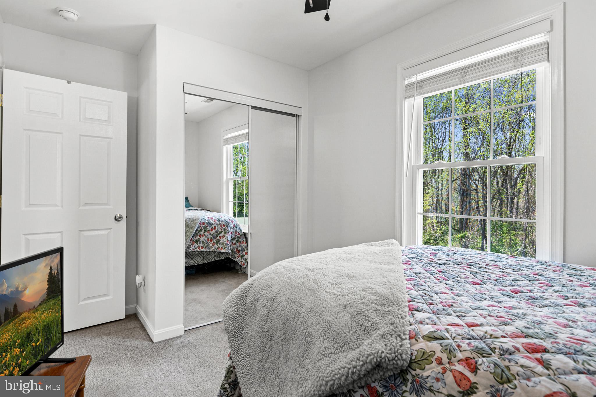 1230 Plum Point Road Huntingtown, MD 20639 - Photo 42 of 79 a bedroom with a bed and a large window