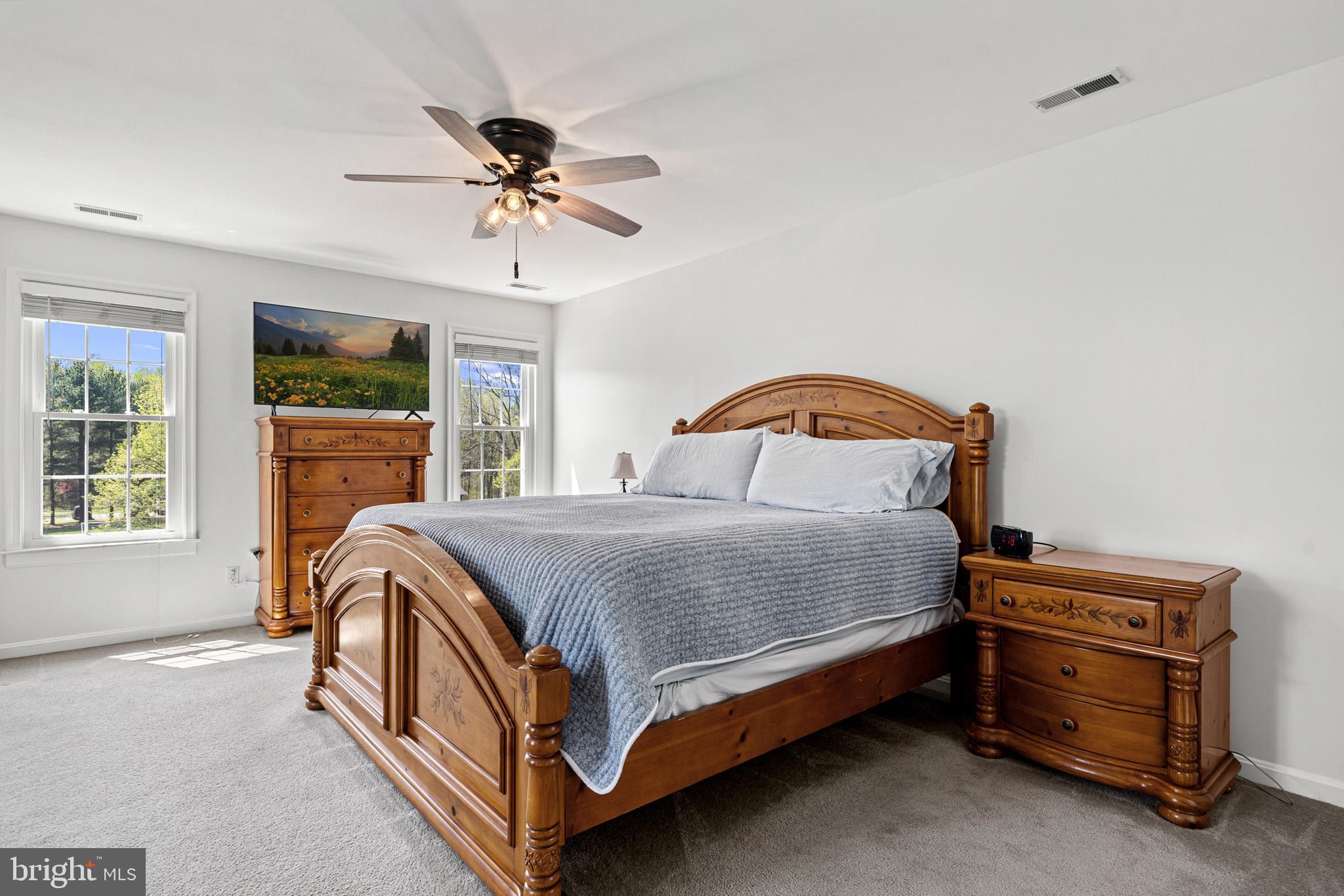 1230 Plum Point Road Huntingtown, MD 20639 - Photo 44 of 79 a bedroom with a bed and a chandelier