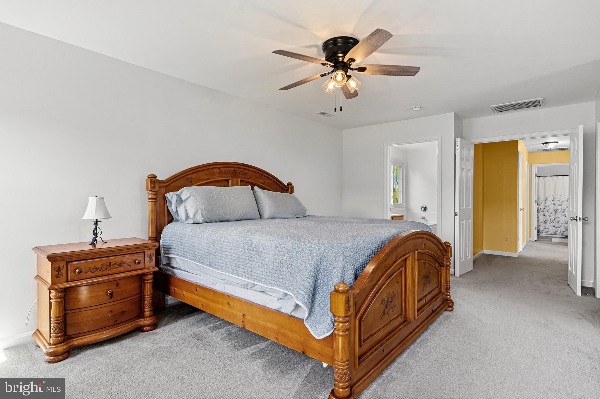 1230 Plum Point Road Huntingtown, MD 20639 - Photo 45 of 79 a bedroom with a bed and a chandelier