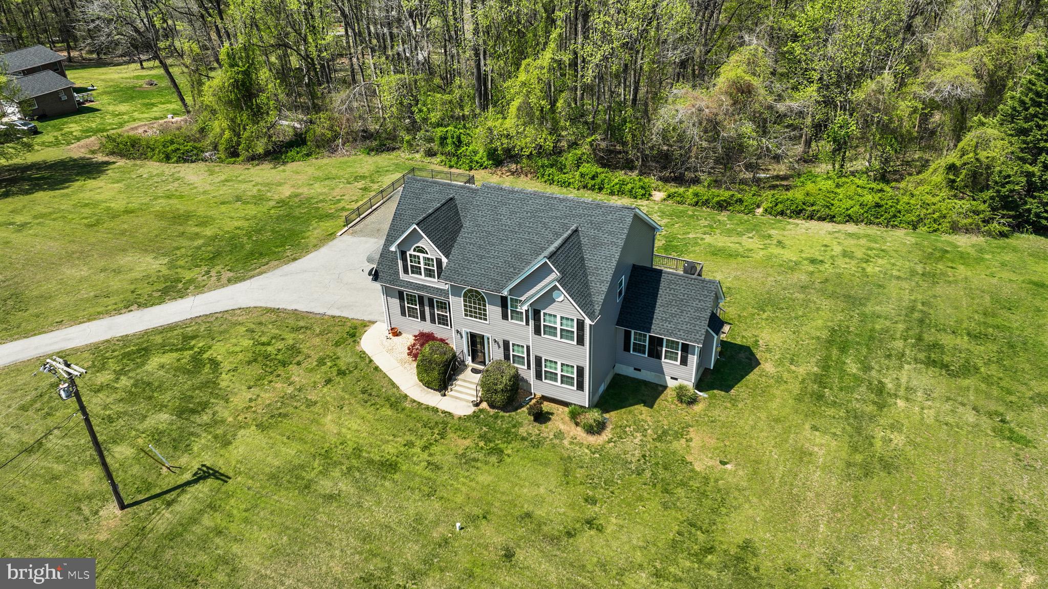 1230 Plum Point Road Huntingtown, MD 20639 - Photo 52 of 79 an aerial view of a house with a big yard and large trees