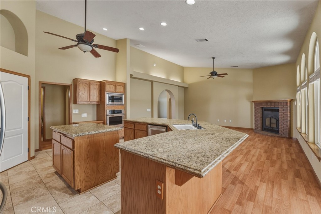 19501 Kinai Road Apple Valley, CA 92307 - Photo 20 of 49 a kitchen with a stove a refrigerator and a sink
