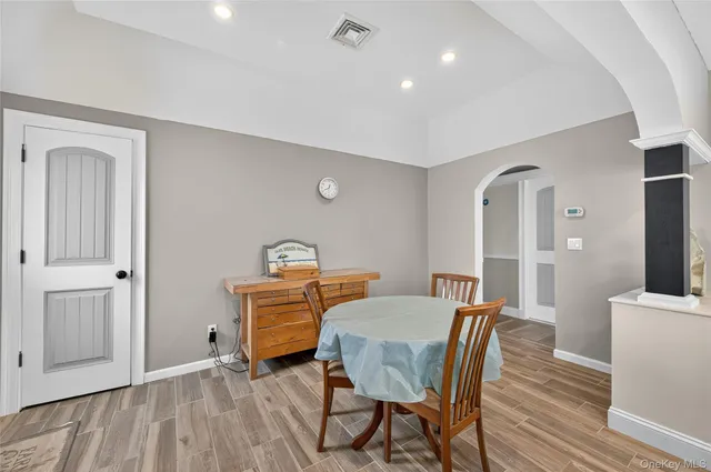 a view of a dining room with furniture and wooden floor