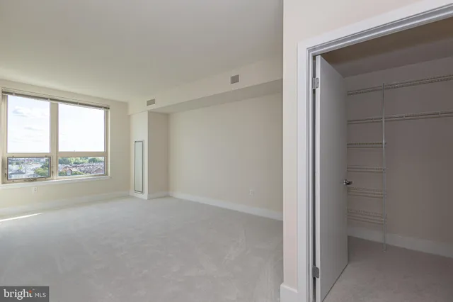 a view of an empty room and a window