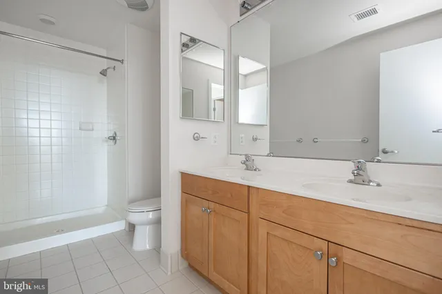 a bathroom with a sink double vanity and a mirror
