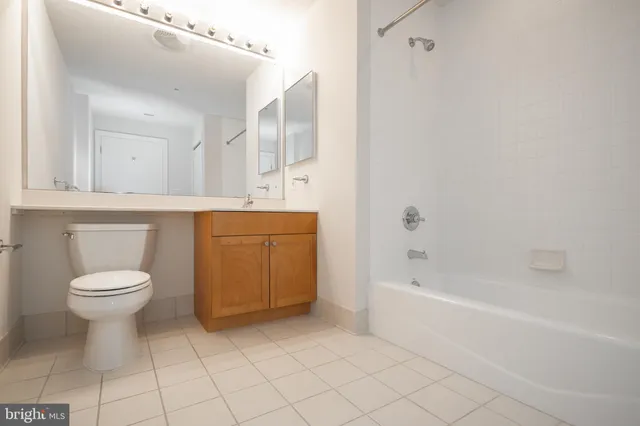 a bathroom with a bathtub sink vanity and mirror