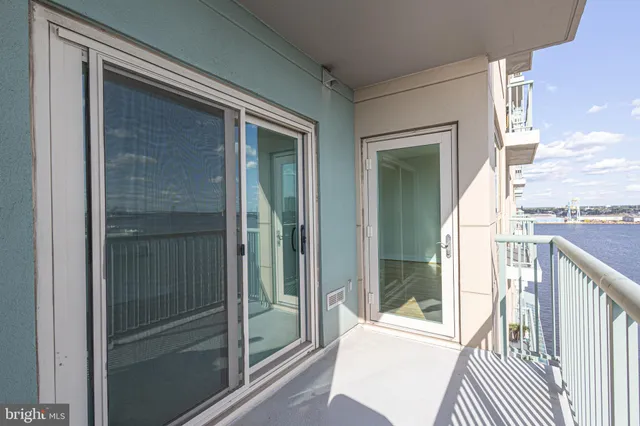 a living room with a table and paintings on the wall