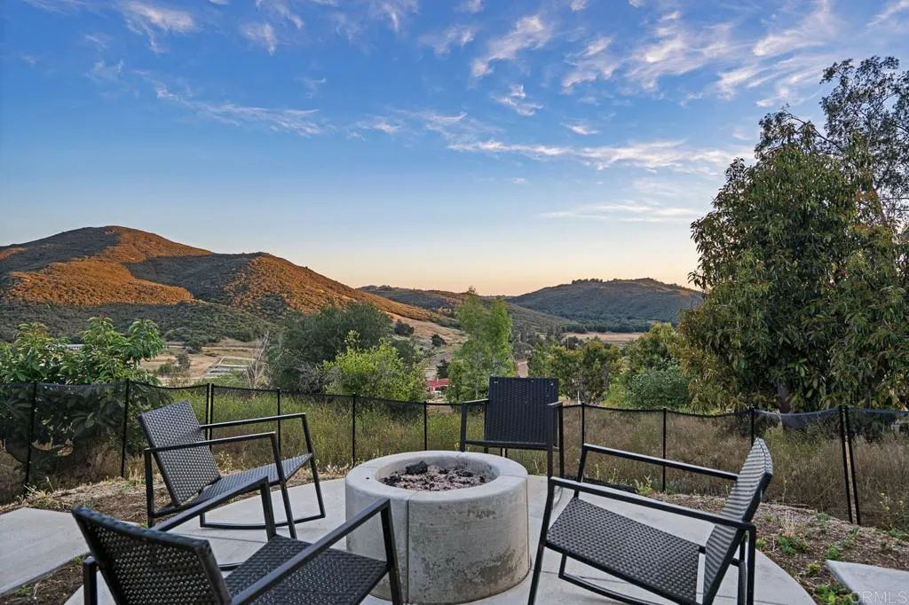 26086 Bear Valley Heights Road Valley Center, CA 92082 - Photo 51 of 65 a view of a chairs and table in the back yard