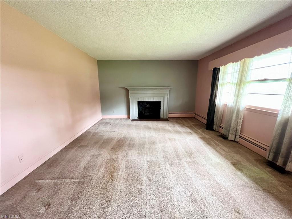3684 Oak Ridge Road Summerfield, NC 27358 - Photo 14 of 42 Formal living room with wood burning fireplace