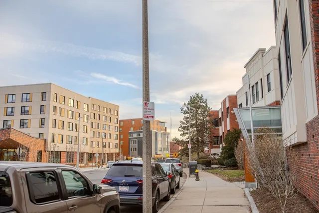 a view of buildings with cars parked