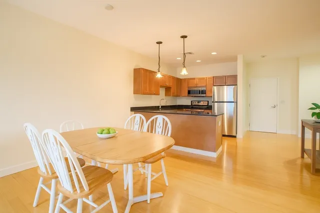 a kitchen with kitchen island a counter top space appliances and a chandelier