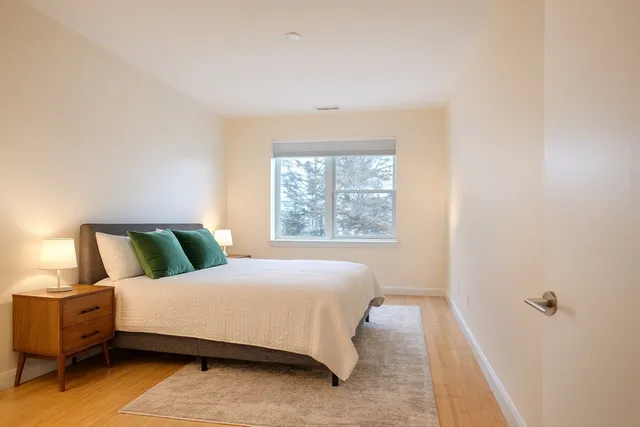 a bedroom with a bed and window