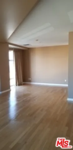 a view of an empty room and wooden floor