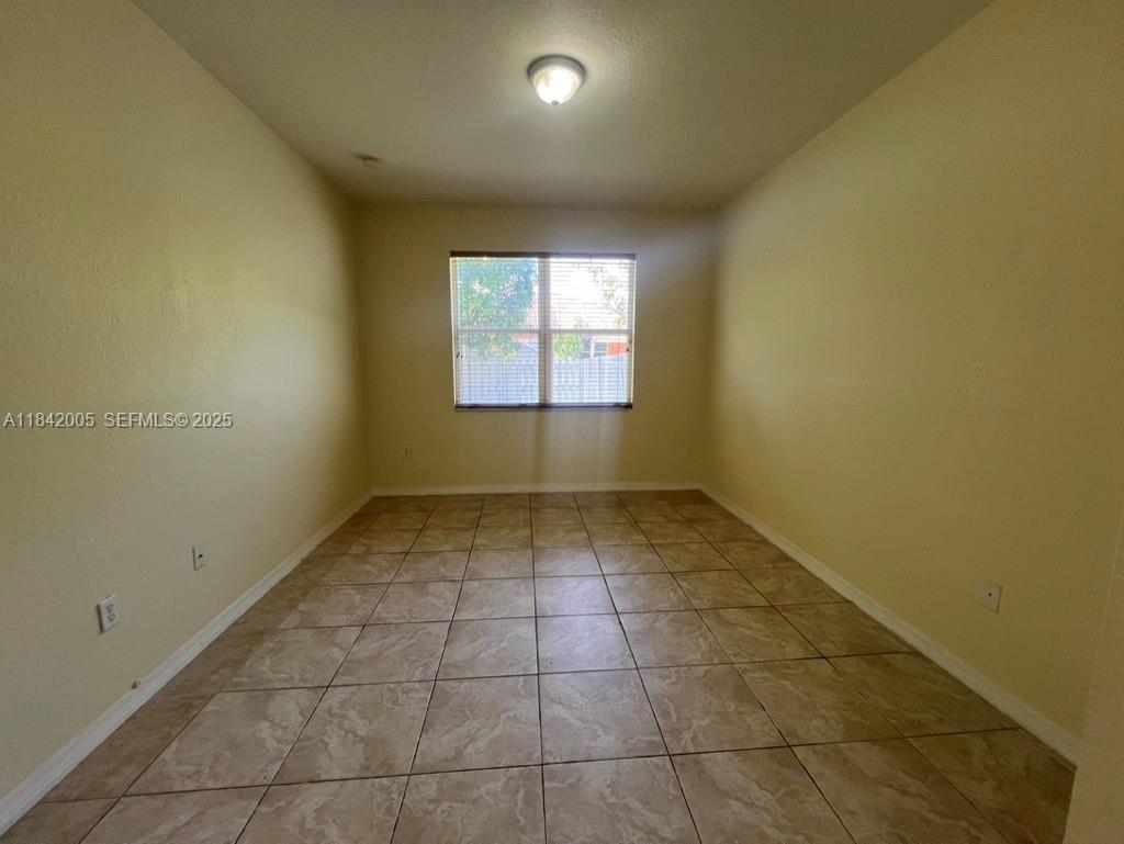 23712 Southwest 110th Avenue Homestead, FL 33032 - Photo 23 of 41 an empty room with a window