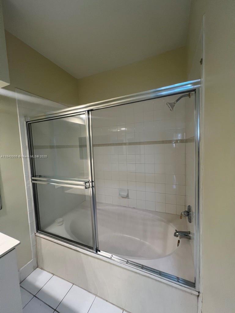 23712 Southwest 110th Avenue Homestead, FL 33032 - Photo 27 of 41 a bathroom with a glass shower door