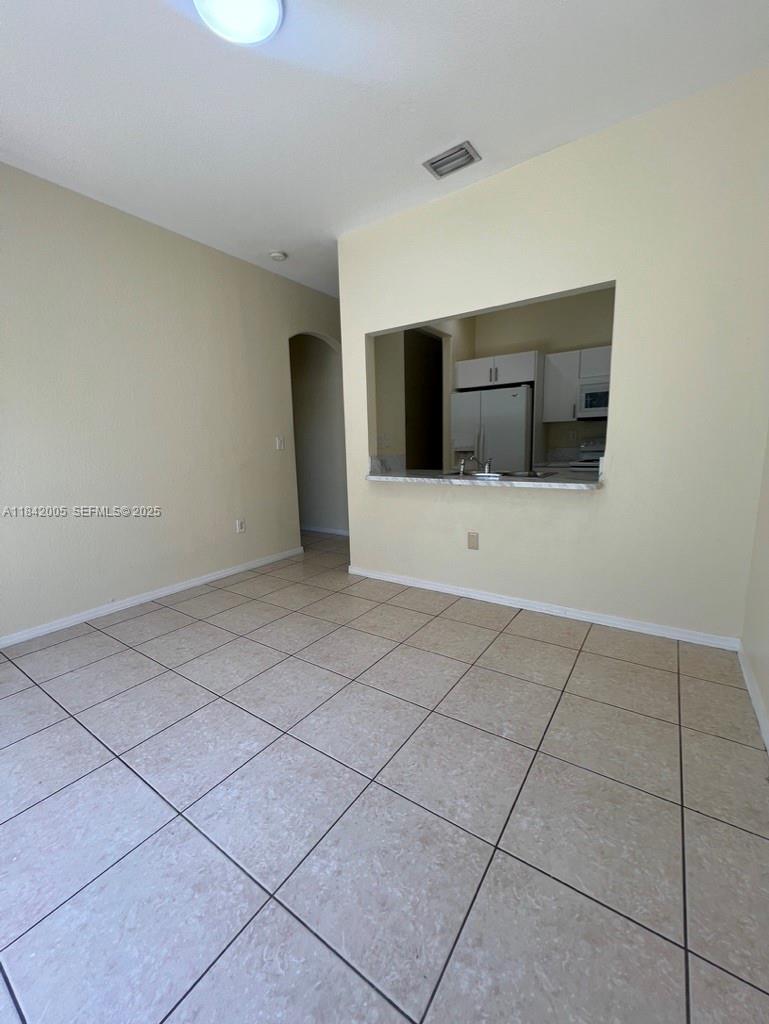 23712 Southwest 110th Avenue Homestead, FL 33032 - Photo 8 of 41 a view of an empty room with a fireplace and a window