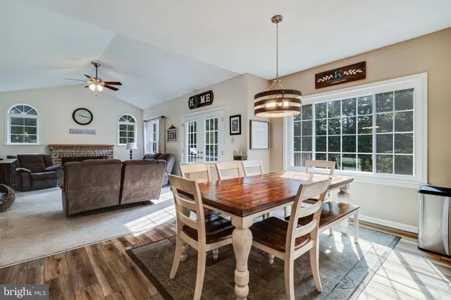 a dining room with furniture window and wooden floor