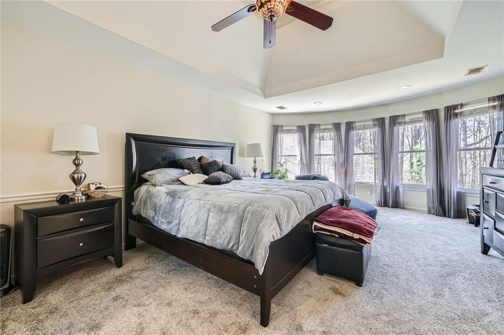 5106 Vining Estates Way Mableton, GA 30126 - Photo 21 of 28 a spacious bedroom with a bed and large windows