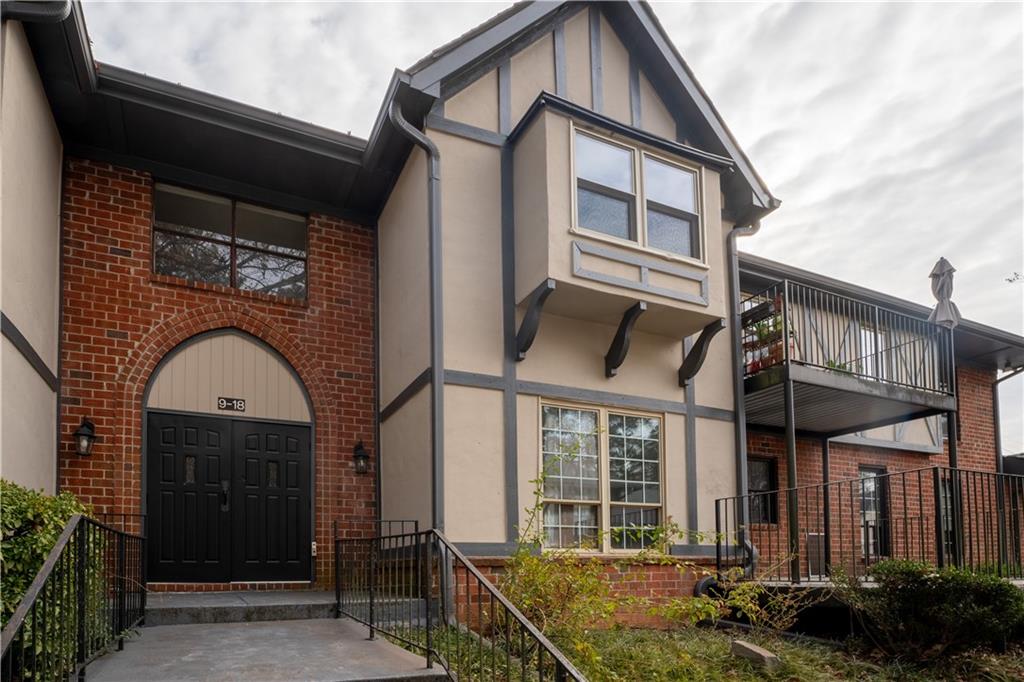 6851 Roswell Road, Unit B17 Sandy Springs, GA 30328 - Photo 1 of 1 a view of a brick house with large windows and a small yard