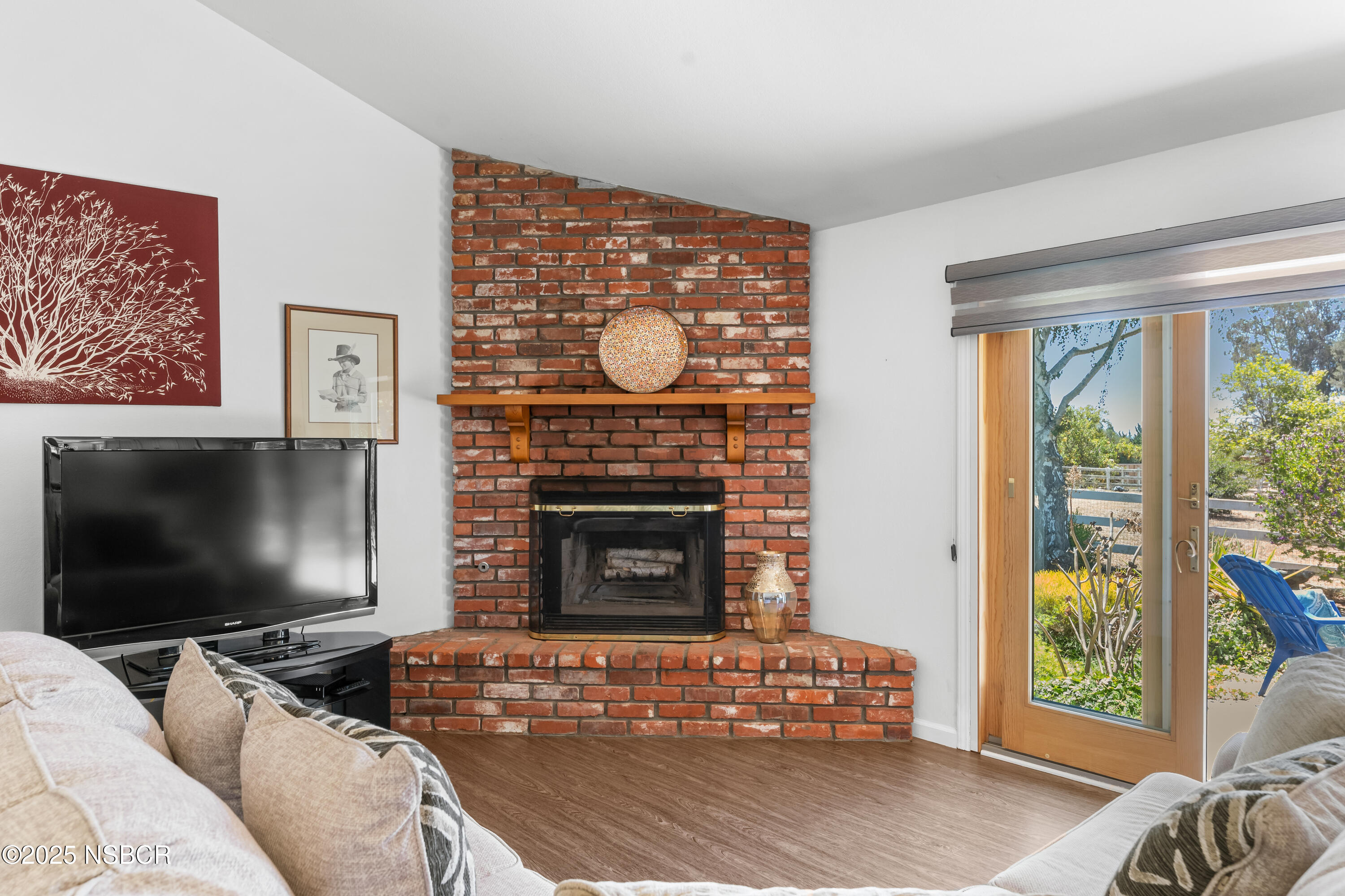 181 Eucalyptus Road Nipomo, CA 93444 - Photo 13 of 36 a living room with furniture a flat screen tv and a fireplace