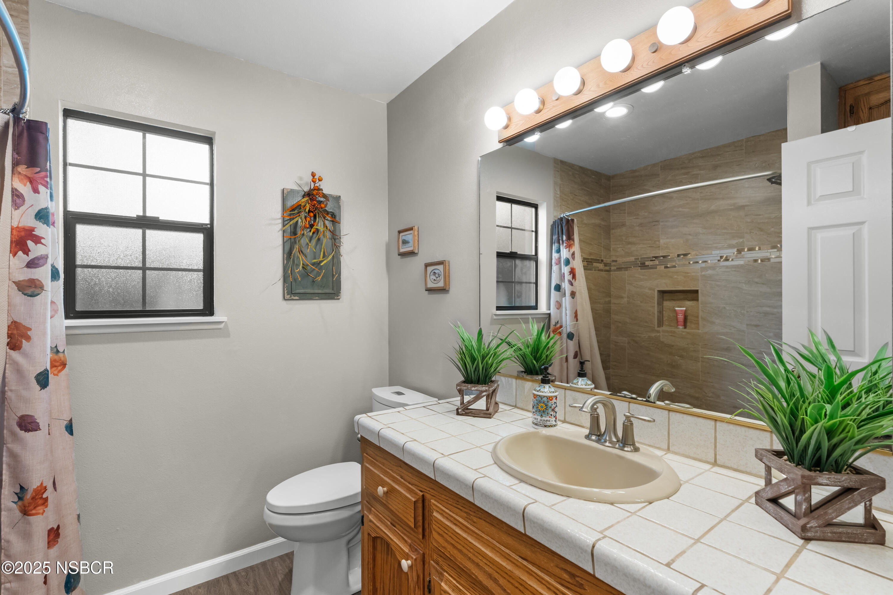 181 Eucalyptus Road Nipomo, CA 93444 - Photo 15 of 36 a bathroom with a granite countertop sink toilet and mirror