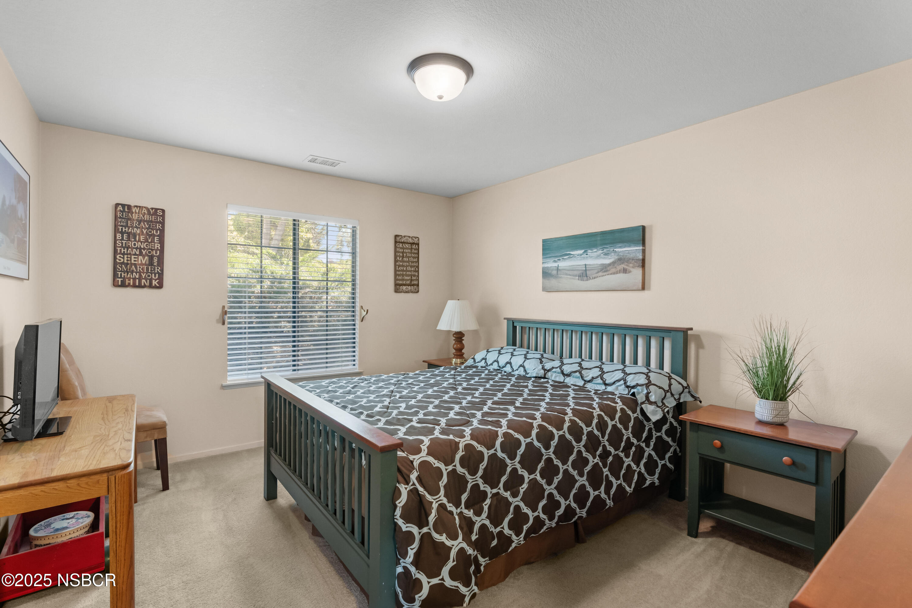 181 Eucalyptus Road Nipomo, CA 93444 - Photo 17 of 36 a bedroom with a bed and a chandelier