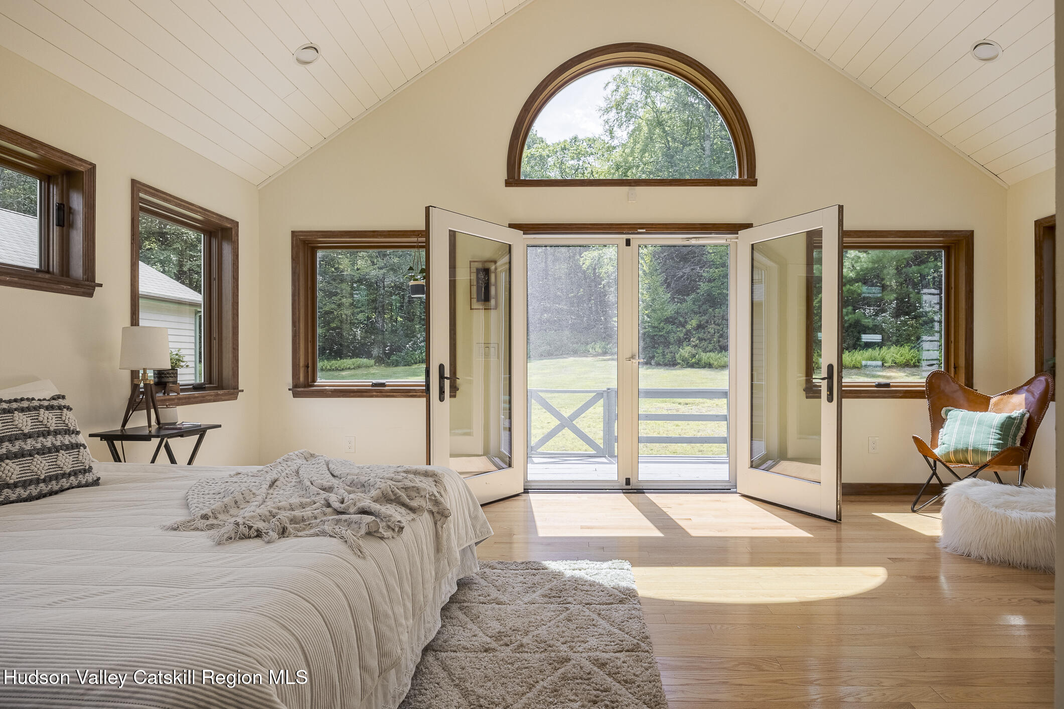 128 Newcut Road Woodstock, NY 12498 - Photo 16 of 51 a bedroom with a bed and glass windows
