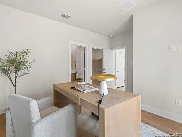 a view of a dining room with furniture and wooden floor