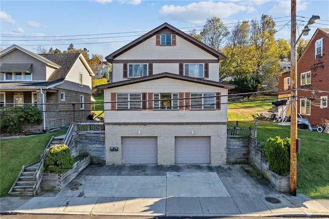 a front view of a house with a yard