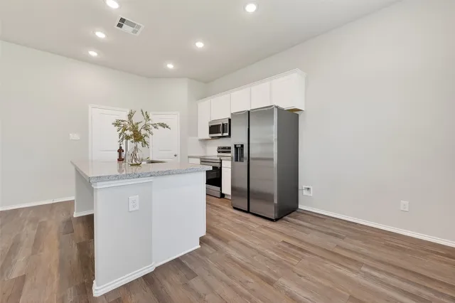 a kitchen with stainless steel appliances a refrigerator and a stove