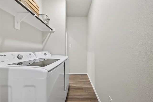 a utility room with a sink dryer and washer
