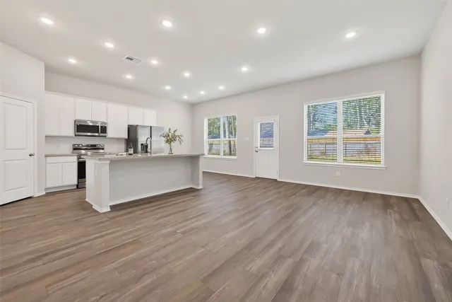 a view of kitchen with granite countertop cabinets and wooden floor