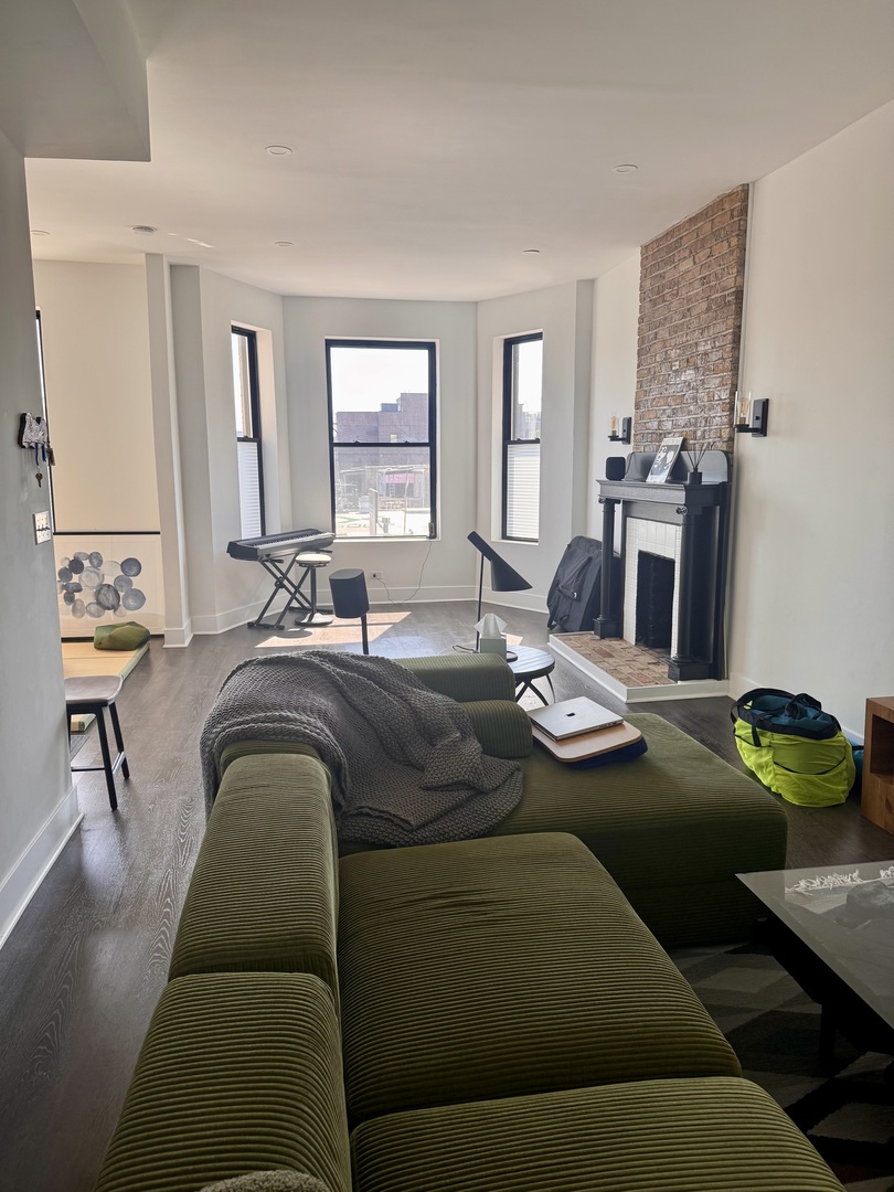 948 West Addison Street, Unit 3 Chicago, IL 60613 - Photo 2 of 11 a living room with furniture and a fireplace