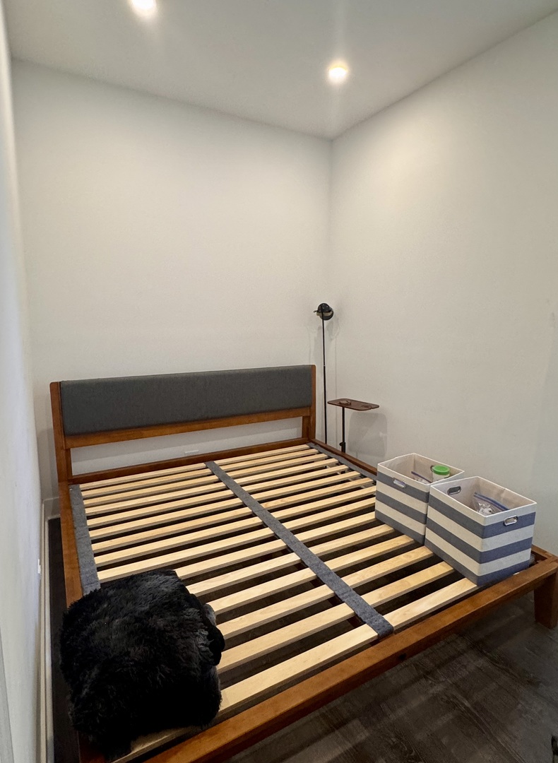 948 West Addison Street, Unit 3 Chicago, IL 60613 - Photo 5 of 11 a bedroom with a bed and a black white wall