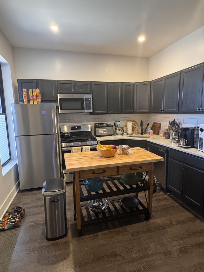 948 West Addison Street, Unit 3 Chicago, IL 60613 - Photo 7 of 11 a kitchen with a sink a stove and a refrigerator